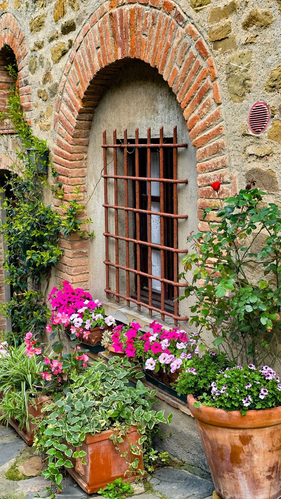Flowers outside a traditional Italian stone house
